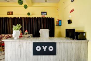 a sign on a counter in a room at Hotel O Taaj Inn Guest House in Bhubaneshwar