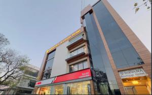 a tall building with a sign in front of it at Nirvana boutique Hotel in Ujjain
