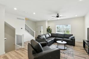 a living room with a couch and a table at Modern Townhome Retreat in Prime Location townhouse in Coralville +25 photos