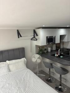 a bedroom with a bed and a kitchen with a counter at Umazis Bespoke Properties- The Hyde in The Hyde
