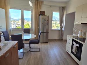 a kitchen with a table and a stainless steel refrigerator at Bellavista Bilocale in Foligno