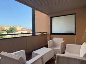 a balcony with chairs and a large window with a screen at Girasole Guest House in Verona