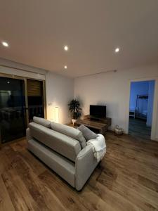 a living room with a couch and a television at Alojamientos, Rafael muñoz in Alcaudete