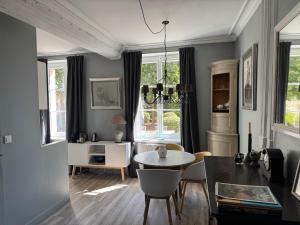 a living room with a table and chairs and a dining room at Le studio du Clos du Bourgage in Saint-Pierre-dʼAutils