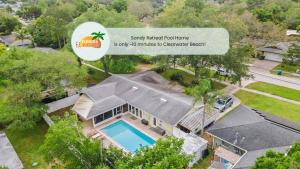 an aerial view of a house with a swimming pool at Sandy Retreat Pool Home - Vacation Rental in Clearwater