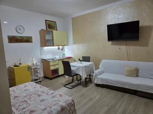 a living room with a couch and a table at Bellavista Monolocale in Foligno