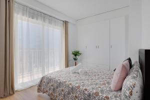 a bedroom with a bed and a large window at La Brisa de Pilar in El Mojón