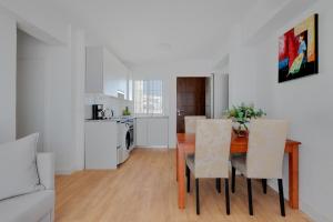 a kitchen and dining room with a table and chairs at La Brisa de Pilar in El Mojón +7 photos