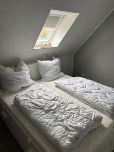 a bed in a room with a window and a bedvisor at Baltic view in Heiligenhafen