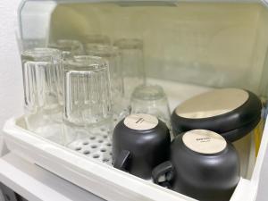 a drawer filled with glasses and other glass items at Near Night Market, 7e, Free Parking in Hat Yai