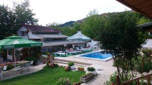 a resort with a swimming pool and a house at Семеен Хотел Сандим in Kŭrdzhali