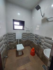 a bathroom with a toilet and a sink at Vista Valley Stay-Gokarna in Kumta