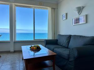a living room with a couch and a table with a bowl of fruit at Direct at the beach - Arguineguin in Arguineguín