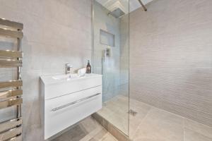 a bathroom with a sink and a glass shower at Kirkstyle Cottage in Coatbridge +23 photos