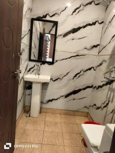 a bathroom with a sink and a mirror at HOTEL SATYA in Dehradun +46 photos
