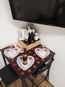 a table with two plates with a bottle on it at La Corte Guest House in Bari