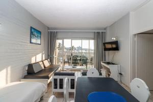 a room with a bed and a couch and a table at Seagull 203 in Margate