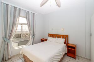 a bedroom with a bed and a large window at Seagull 203 in Margate +5 photos