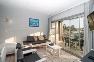 a bedroom with a bed and a balcony with a view at Seagull 203 in Margate