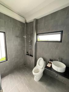 a bathroom with a toilet and a sink at บ้านK village in Ban Rawoeng +6 photos