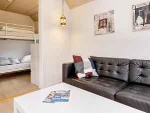 a living room with a couch and a bunk bed at 6 person holiday home in Løkken in Løkken