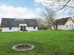 a house with a large yard with a fire pit at 6 person holiday home in Løkken in Løkken