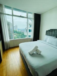 a bed in a room with a large window at Vortex Suites Dream By KL in Kuala Lumpur