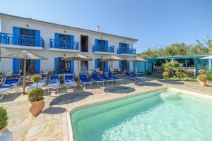 a villa with a swimming pool in front of a building at Katigiorgis Blue Hotel & Bungalow SPA Resort in Agios Georgios