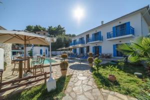 a resort with a swimming pool and a building at Katigiorgis Blue Hotel & Bungalow SPA Resort in Agios Georgios