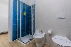 a bathroom with a shower and a toilet and a sink at Prime Living Milano Merlata - Balcony Apartment in Milan +18 photos