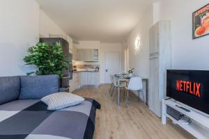 a living room with a bed and a kitchen at Prime Living Milano Merlata - Balcony Apartment in Milan