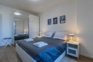 a bedroom with a large bed with two pillows at Prime Living Milano Merlata - Balcony Apartment in Milan