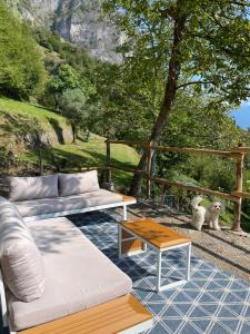 a living room with a couch and a table at Chalet Como Lake - Nature Retreat, foot access only in Griante Cadenabbia