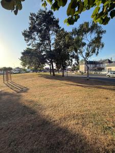 a park with trees in the middle of a field at Studio au cœur du village d'arts in Dives-sur-Mer