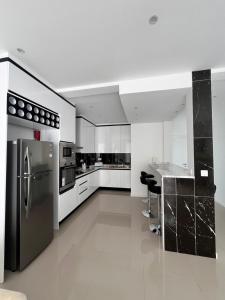 a kitchen with a stainless steel refrigerator and a counter at Casa BB&Djassi - Apartment T2 in Ponta do Sol