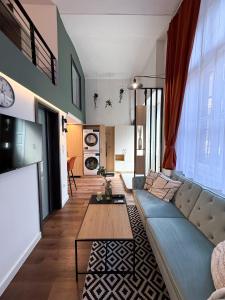 a living room with a blue couch and a table at T25 Urban Green Hideaway in Budapest