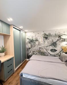 a bedroom with a bed and a wall mural at T25 Urban Green Hideaway in Budapest