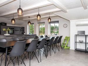 a dining room with a long table and chairs at Luxury Retreat with Pool - By Traum Ferienwohnungen in Henne Strand +25 photos