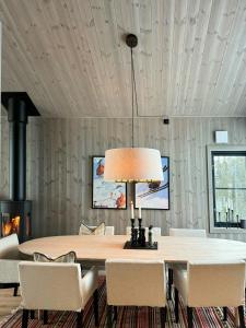 a dining room with a table and chairs and a fireplace at Modern Family Cabin In Norefjell Ski-Inout in Surteberg
