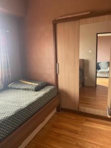 a bedroom with a bunk bed and a mirror at Apartemen Tamansari Panoramic amanah in Bandung