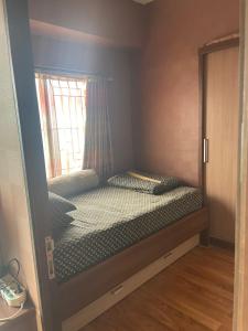 a small bedroom with a bed with a window at Apartemen Tamansari Panoramic amanah in Bandung