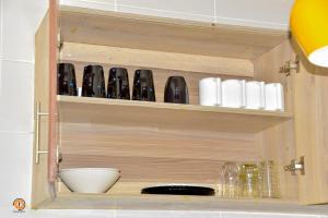 a cupboard with a bunch of items in it at Eldoret 3bedroom Apartment in Eldoret +14 photos