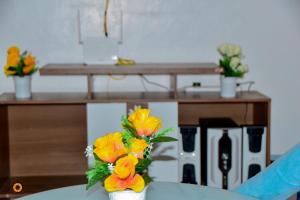 a vase filled with flowers on top of a table at Eldoret 3bedroom Apartment in Eldoret