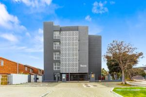 a building with a lot of windows on it at The Orion 18 by Host Agents in Table View