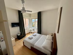 a bedroom with a bed and a large window at Hotel Locanda Castagnola in Lugano