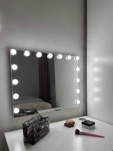 a bathroom with a mirror and a table with a makeup brush at Calma Mediterránea in Aguadulce +26 photos