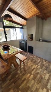 a large room with a table and a kitchen at Refúgio da natureza in São Francisco do Sul