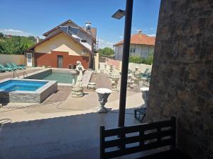 a patio with a swimming pool and a house at Casa Rico in Tulcea