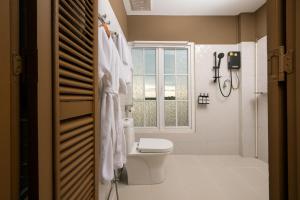 a bathroom with a toilet and a window at Ali Grand Hotel in Vientiane +39 photos