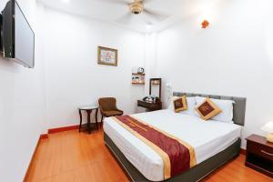 a bedroom with a bed and a flat screen tv at Belvilla Near Quang Trung Exhibition Center District 12 Formerly Southern Star Hotel in Ho Chi Minh City +23 photos